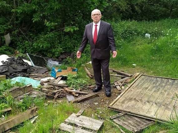 Councillor George Davies with some of the dumped rubbish