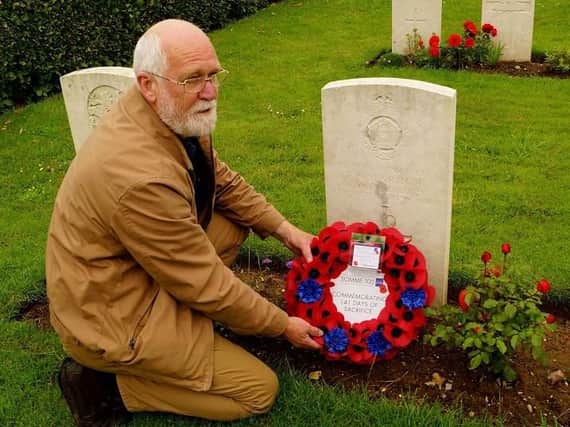 Rev David Long at a soldier's grave at The Somme