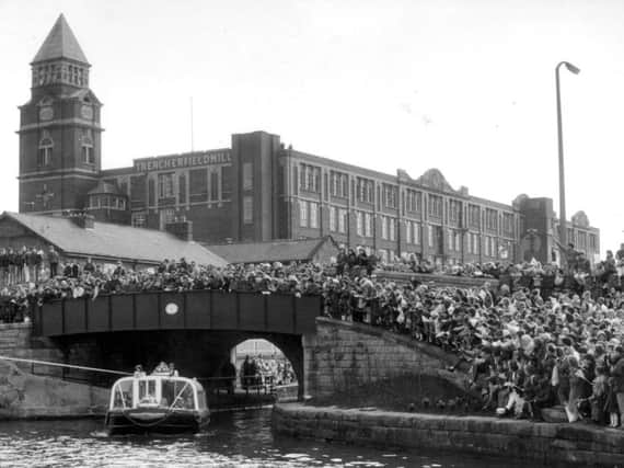 It's the mid 80s and hundreds of people await the arrival of the Queen at Wigan Pier to perform the official opening ceremony
