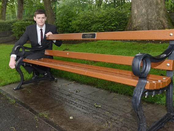 Former councillor Nathan Murray with the bench in memory of ex-Wigan Council employee Kevin Mulkeen