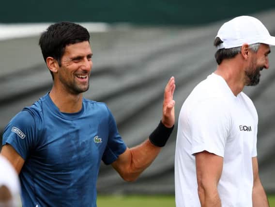 Novak Djokovic of Serbia speaks with Goran Ivanisevic during a practice session (Photo by Clive Brunskill/Getty Images)