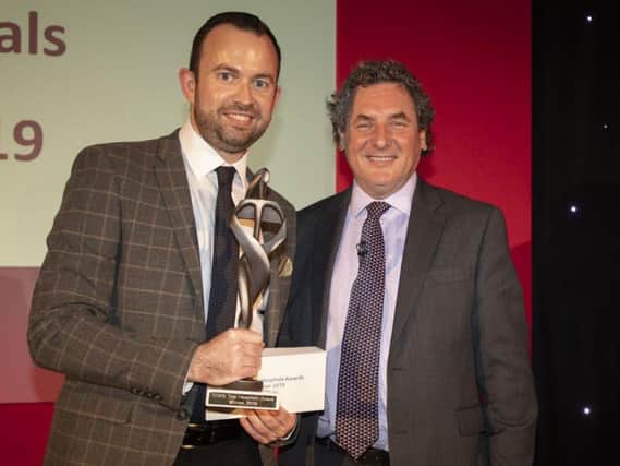 Director of Operations Shaun Curran (left) receives the award from Chris Baker, CEO of Capita Software.