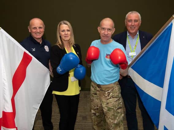 Wigan Council's armed forces workers ahead of the match at The Edge with a veteran and Leigh Amateur Boxing Club