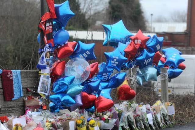 Flowers and balloons left at the car park in Bickershaw Lane where Billy was killed
