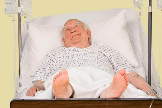 Actor Ed Asner in a hospital bed