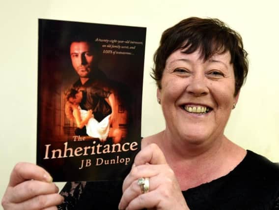 Jeanette Ellmer with her book The Inheritance