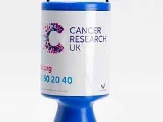 A Cancer Research charity box