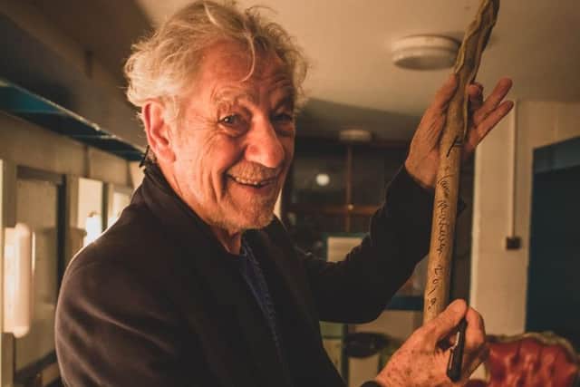 Sir Ian McKellen signs the staff used in the Dukes outdoor theatre production of The  Hobbit. A lottery will give fans the chance to win the signed staff