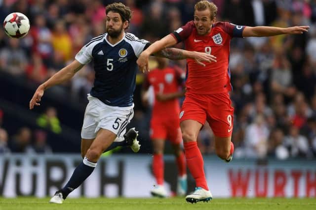Charlie Mulgrew, playing for Scotland, battles England captain Harry Kane