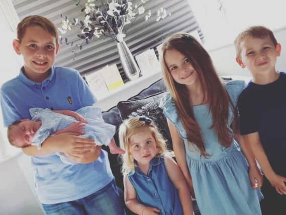 Ryley holding baby Dolly, Lillia, Tilly May and Bobby