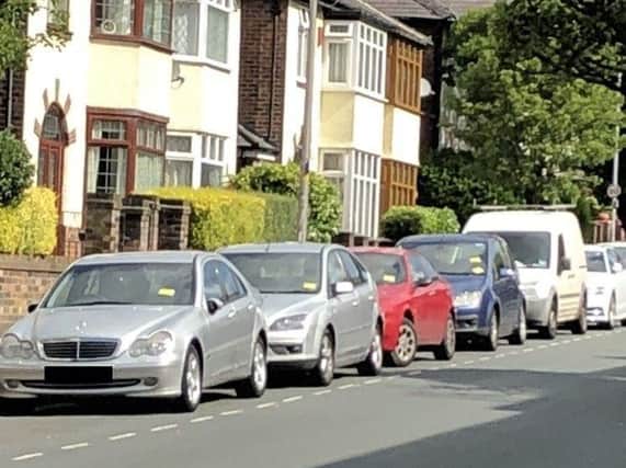A row of cars with penalty notices