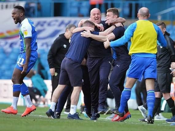 Paul Cook and his staff enjoy a famous win at Leeds