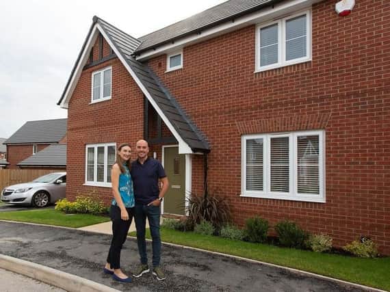 Hannah and Ian outside their new home; Ian proposed to Hannah on the day they got their keys