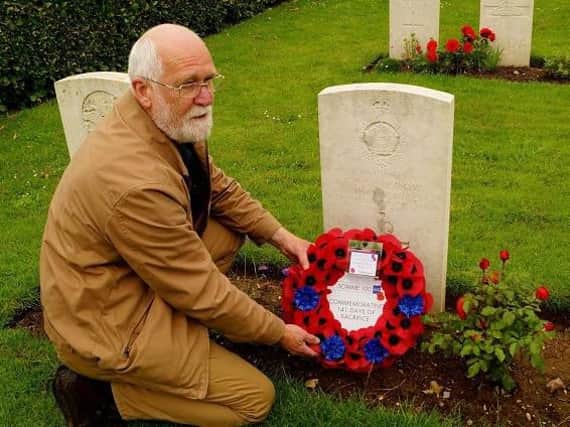 Rev David Long visiting the grave of Private F.S. Marrow at the Somme