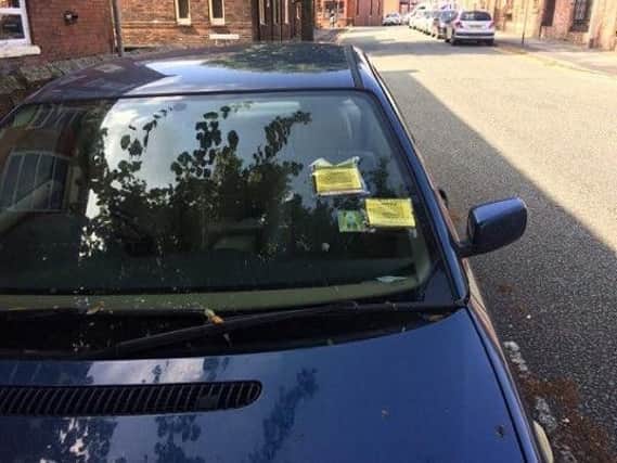 A vehicle with several parking fines on Acton Street