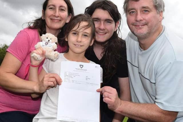 Eight-year-old Ellie Barnes celebrates gaining the top grade, nine, in her maths GCSE exam, pictured with proud family, mum Angela, brother Thomas,12, and dad Simon, right