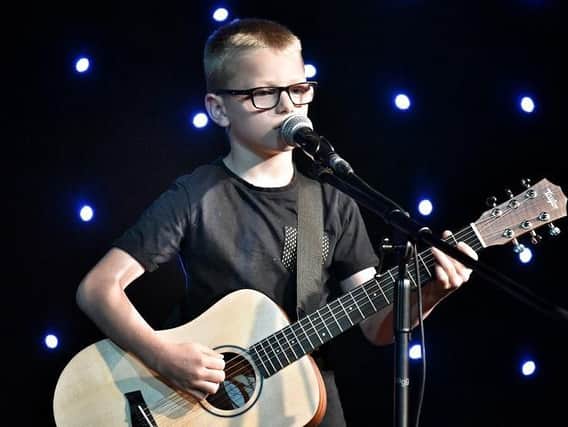 Singer and guitarist Kai Berry, nine, shows off his skills