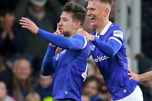 Lang celebrates scoring for Oldham. Photo credit: PA