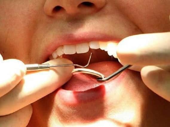 The number of free NHS dental treatments in Wigan has fallen by more than a quarter