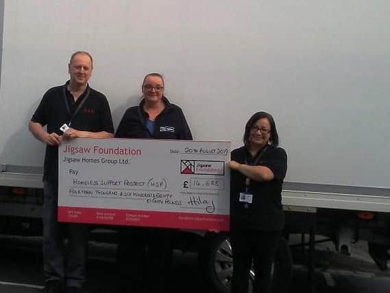 Homeless Support Project workers with a cheque from the Jigsaw Foundation