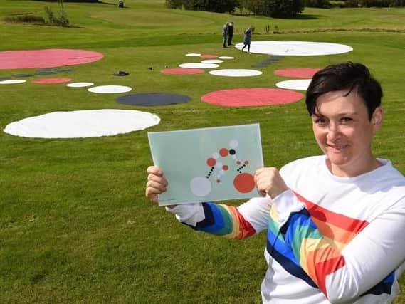 Artist Dani Gaines is creating a giant work of art, with the help of volunteers, on the grounds of the FootGolf course at Haigh Woodland Park, to celebrate the Tour of Britain passing by on Saturday