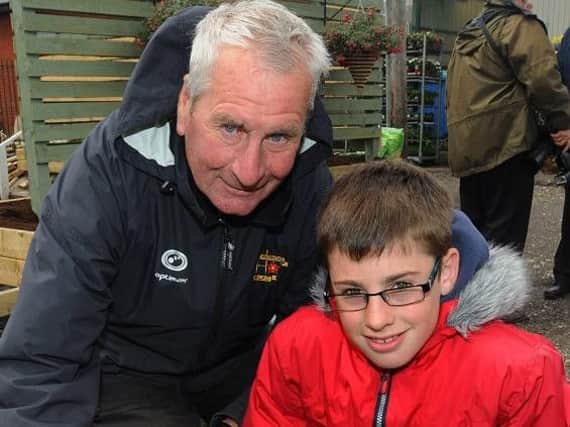 Much-loved George Herring with his grandson Josh, creating a club memorial garden in 2011