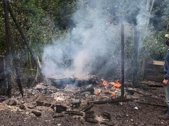 The smouldering ruins of the reception and signing-in cabin