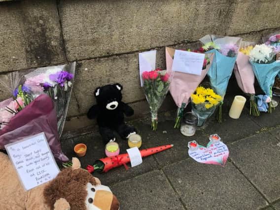 Floral tributes are left on a bridge in Radcliffe, Greater Manchester