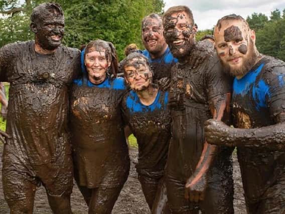 Mucky fund-raisers from Wigan take part in the Tough Mudder race to raise money and awareness for Mind