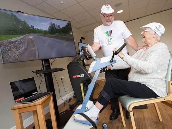 Residents Norman Thomas and Audrey Johnson taking on the cycling competition at Belong Wigan