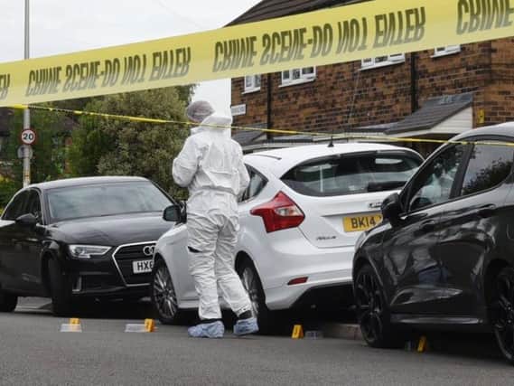 Forensics comb the scene in Vicarage Road