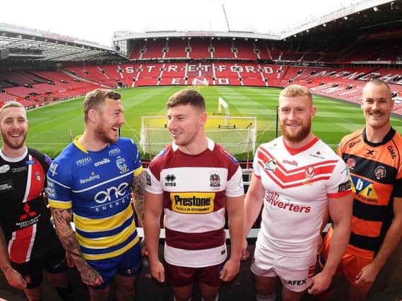 George Williams shares a joke with his former team-mate Josh Charnley at a media event to launch the play-offs at Old Trafford yesterday