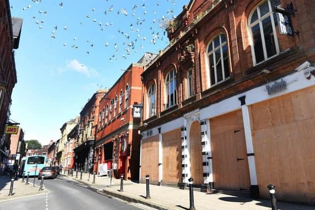 King Street with many buildings including the Royal Court Theatre boarded up