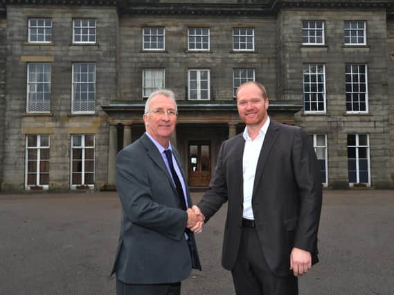 Council leader David Molyneux shakes hands with Craig Baker, director of Contessa Hotels, when the deal was first struck