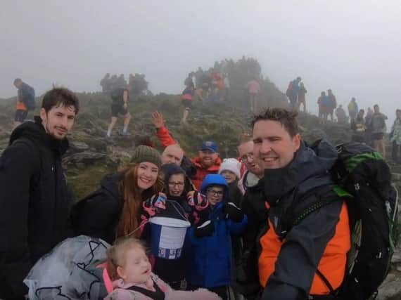 Friends and family of Hallie Campbell took her up Snowdon in her wheelchair as part of efforts to raise 70,000 for her to have medical treatment in Poland