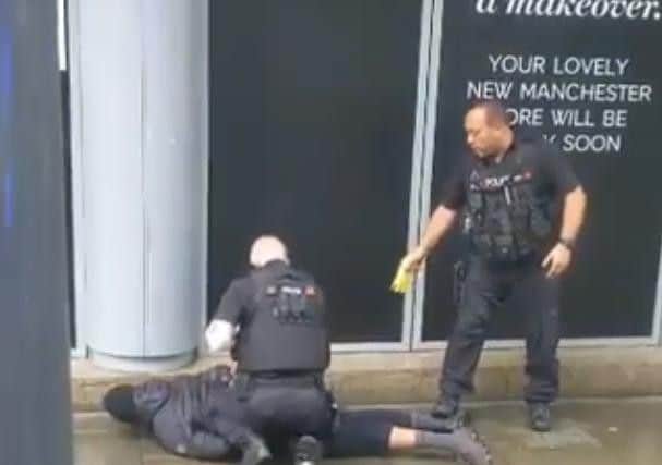 Police detain a suspect at the shopping centre