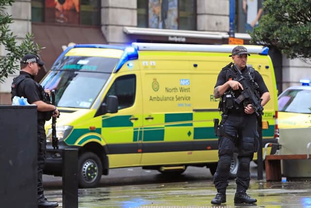 Armed police have the shopping centre on lockdown. Photo: PA