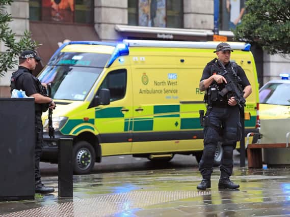 Armed police have the shopping centre on lockdown. Photo: PA