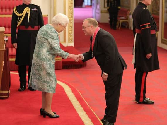 Stuart Crooks at Buckingham Palace with the Queen