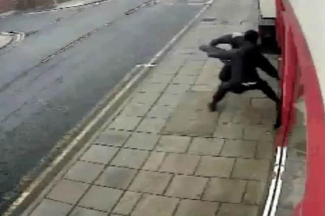 The masked men smash their way into the Post office