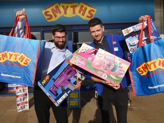 Smyths duty managers Matt Finney and Nathan Lee, right, outside the store, with their top festive toys