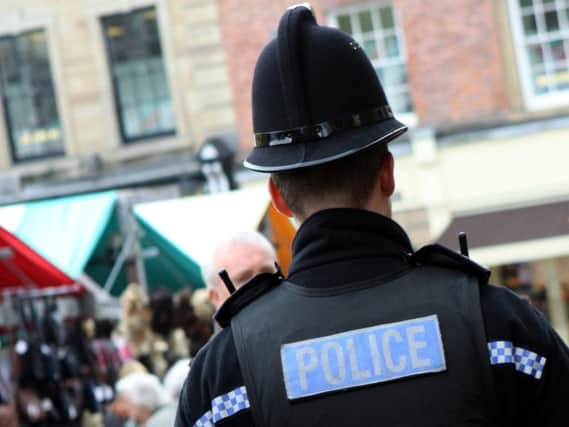 Two police officers were assaulted while arresting a woman for a stabbing in Leigh