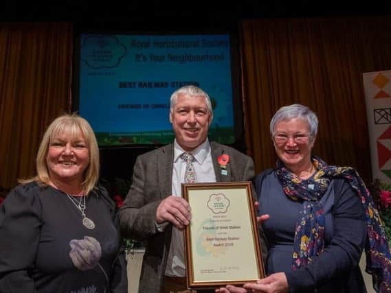 Ann and Bill receive the award from a representative from the sponsors Jigsaw Homes Group