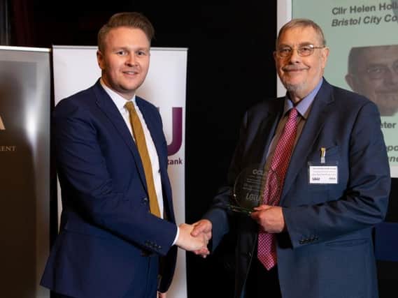 Lord Peter Smith, right, collects his award from LGiU chairman Coun Michael Payne