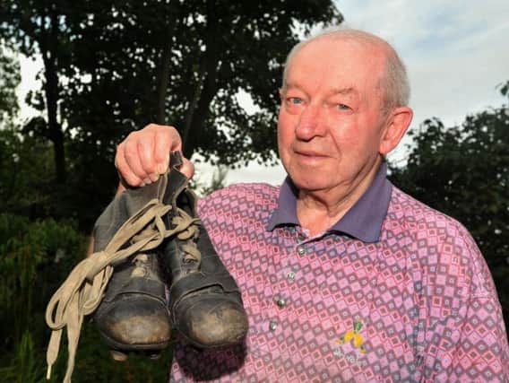 Les Campbell, with the boots he wore on his debut with Latics in 1952