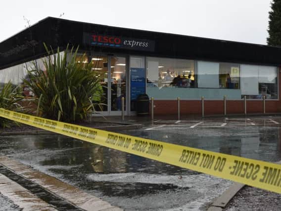 Police tape across the entrance to the Tesco Express store