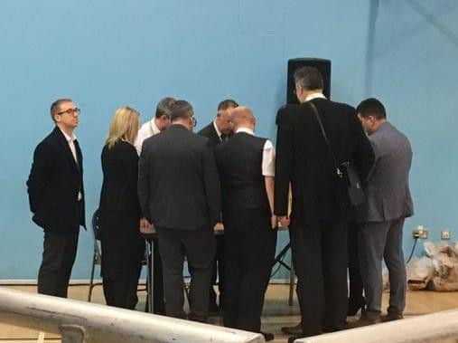 Candidates in a huddle at the Leigh count as the results come in