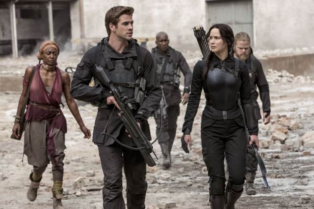 Liam Hemsworth and Jennifer Lawrence in The Hunger Games: Mockinjay - Part 1