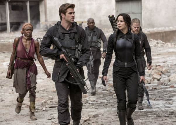 Liam Hemsworth and Jennifer Lawrence in The Hunger Games: Mockinjay - Part 1