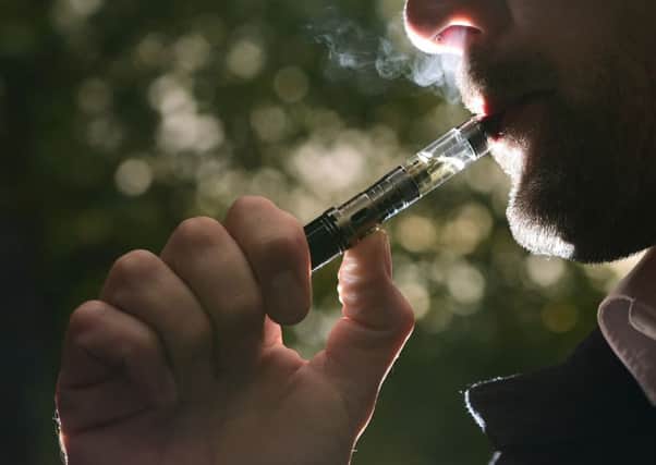 A man 'vaping' on an e-cigarette